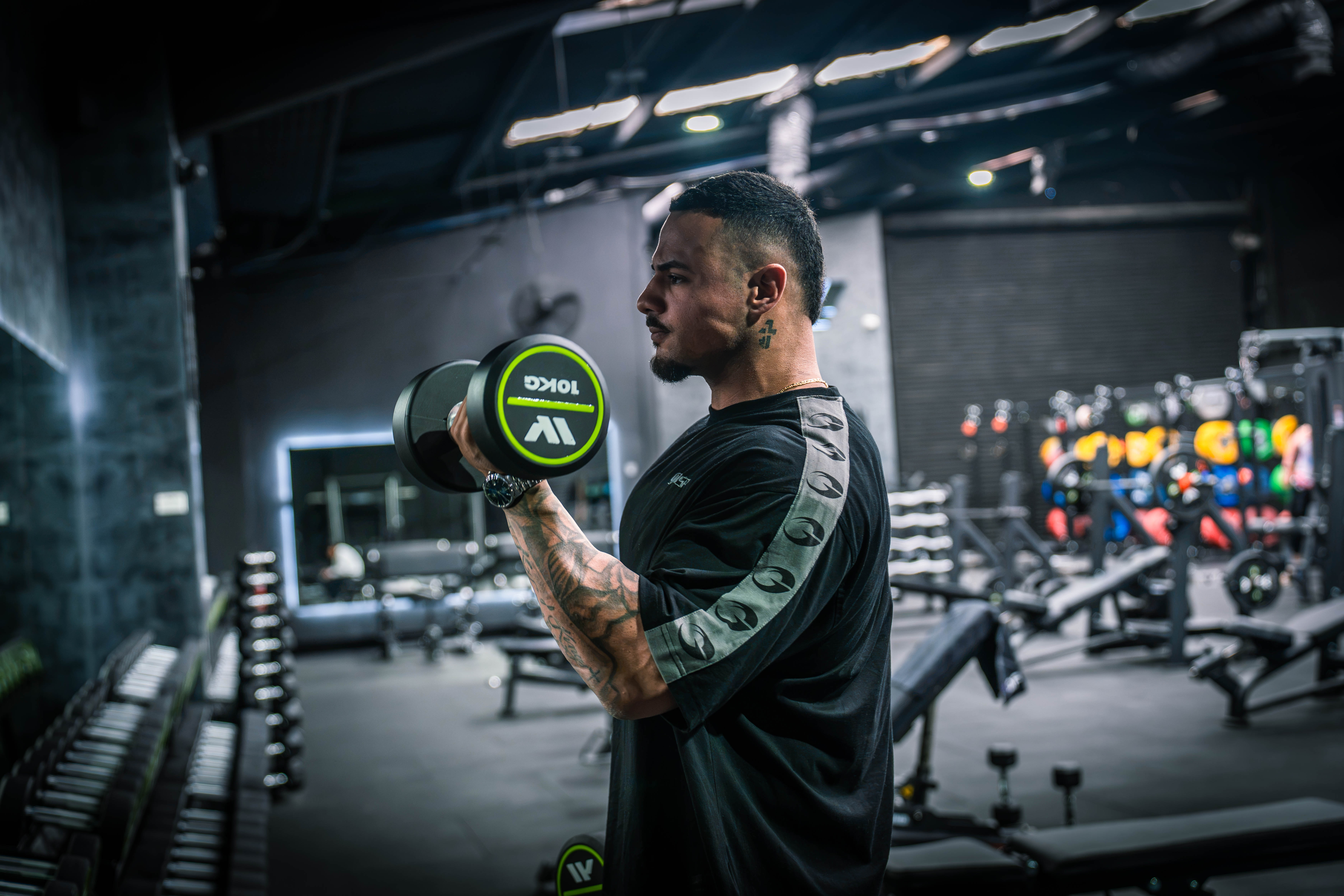 Angelo Yazbek lifting a dumbbell in the gym